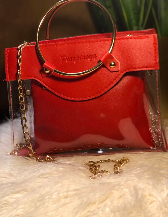 Red translucent ring bag with gold chain and red removable pouch
