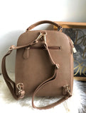 Modern taupe backpack with gold accents